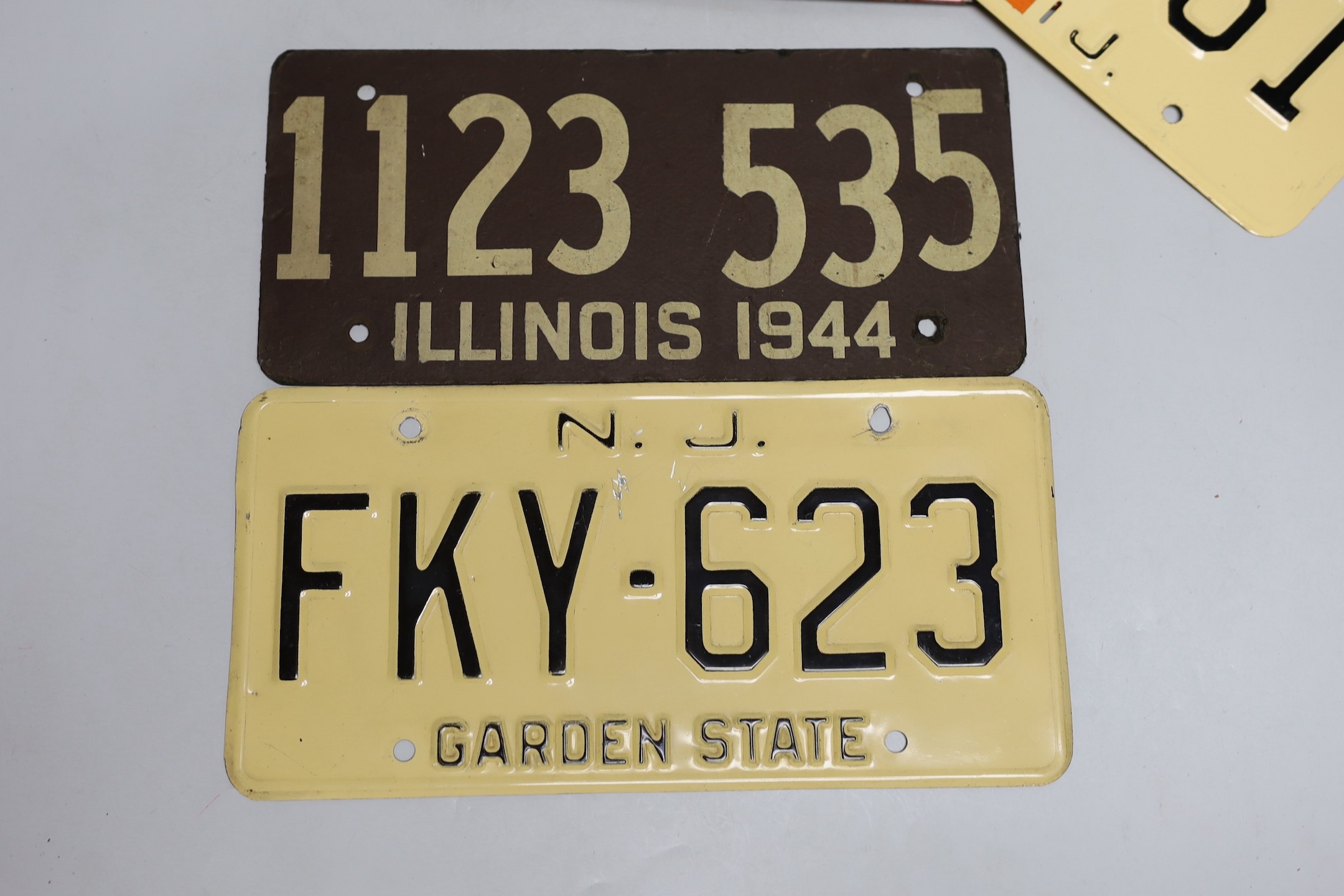 A mixed group of nine USA enamel car registration number plates